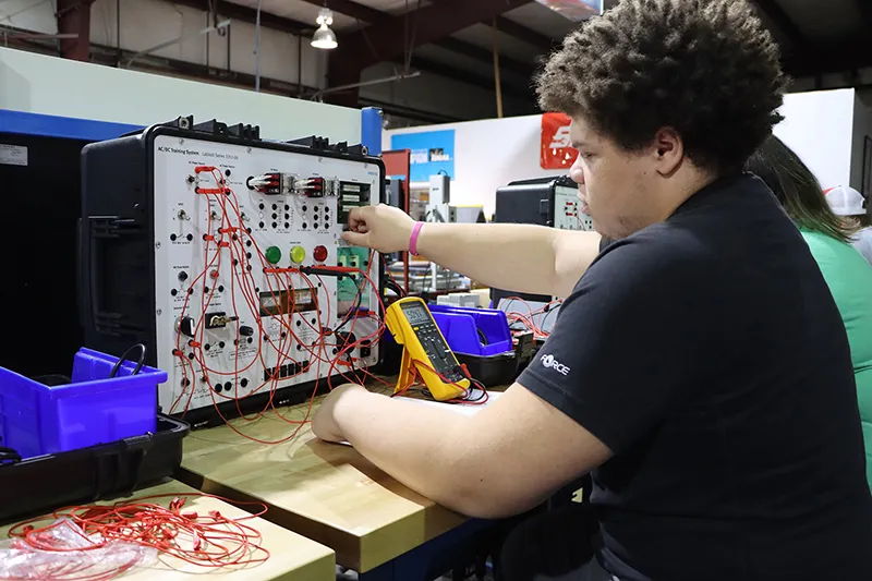 Student in classroom on equipment.